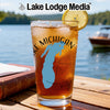 Glass with Michigan outline and "Lake Michigan" text, on a wooden table.