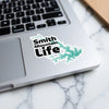 Smith Mountain Life sticker with teal water outline on a laptop.