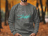 Gray sweatshirt with "Beautiful Lake Ouachita Arkansas" and compass rose design.