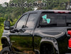 Black pickup truck with "Sylvan Life" sticker on the rear window and "Lake Lodge Media" text.