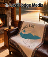 Woven throw blanket with Lake Erie map design on a leather couch.