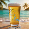 Beer glass with Lake LBJ map and compass on a beach at sunset.