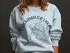 Light blue sweatshirt with Chickamauga Lake compass and Tennessee text.