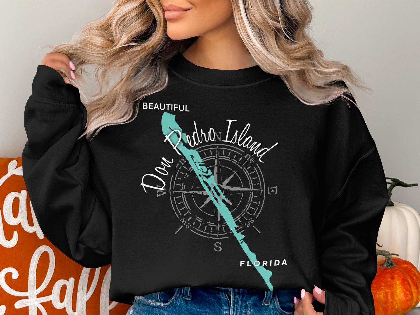 Black sweatshirt with "Don Pedro Island" and compass graphic.