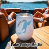 A white stainless steel wine tumbler with Snow Lake, Washington graphic on a wooden table aboard a boat.