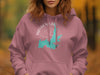 Pink hoodie with teal Hayden Lake, Idaho map and compass design.