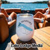 A white insulated wine tumbler with Lake Wenatchee printed on it, sitting on a boat table.
