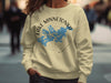 Cream sweatshirt with blue Lake Minnetonka graphic and compass design.