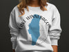 White crewneck sweatshirt with Lake Winnebago Wisconsin map and compass design.