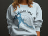 Powegama Lake Minnesota graphic on light blue sweatshirt with compass rose.