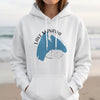 White hoodie with blue Lake Manawa Iowa map and compass graphic.