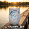 A white insulated tumbler featuring a Green River Lake, Kentucky map graphic sits on a wooden dock.