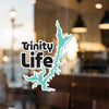 Sticker with "Trinity Life" text and a teal lake outline.