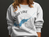 White sweatshirt with "Cedar Lake Ontario" text, lake outline, and compass graphic.