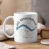 White mug with Lake Minnewanka map and compass graphic, "Banff" text.