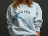 Light blue sweatshirt with Maligne Lake map graphic and compass design.