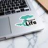 Turquoise map sticker with "Silverwood LIFE" text on a laptop.