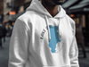 White hoodie with a blue silhouette of Lake Tahoe and compass rose graphic.