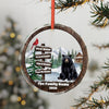 Round ornament with black bear, cardinal, cabin, and personalization for names and year.