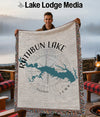 Man holds up a woven blanket with a map of Rathbun Lake, Iowa, and a compass rose.