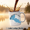 White mug with "Clearwater Lake Minnesota" design and coffee pouring.
