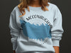 Light blue sweatshirt with Lake McConaughy Nebraska map graphic and compass.