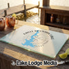 Glass cutting board featuring an Eagle Mountain Lake map graphic rests on a wooden outdoor bar.