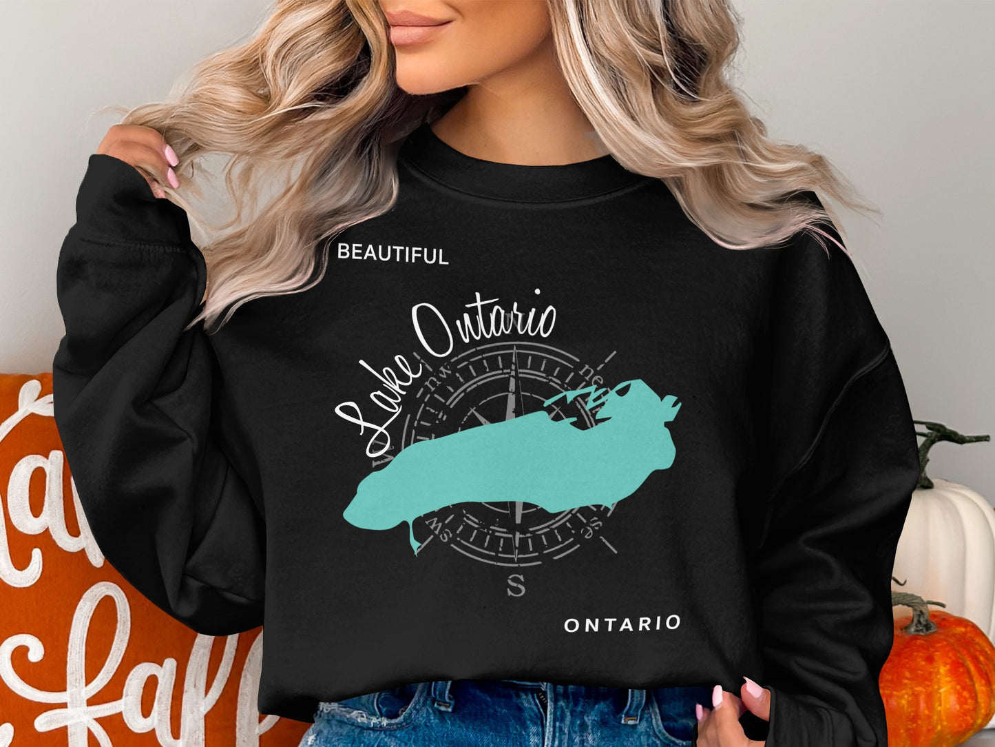 Black crewneck sweatshirt with a turquoise outline map of Lake Ontario.