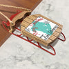 Wooden sled ornament with red metal runners and "Merry Christmas FROM Lake Itasca" text.