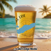 Glass of beer with Lake Erie outline and compass on beach background.