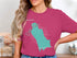 Teal outline map of Lake, Washington with compass rose on pink t-shirt.