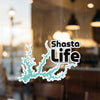 Shasta Life decal with a teal lake outline on a glass surface.