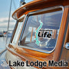 A teal Aziscohos Lake sticker on a boat window above "Lake Lodge Media" text.