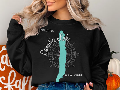 Black sweatshirt with "Beautiful Canidice Lake New York" and compass graphic.