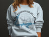 Light blue crewneck sweatshirt with a compass and map graphic of Lake Ossawinamakee, Minnesota.
