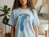 Light blue t-shirt with Lake Michigan map and compass graphic.