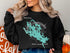Black sweatshirt with a teal map of Lake Winnipesaukee, New Hampshire.