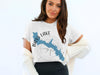 White t-shirt with Bass Lake, California map and compass design.