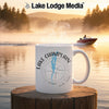 White mug with "Lake Champlain" and compass design on a lake background.