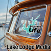 Turquoise Jocassee Life sticker on a wooden boat window.