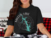 Black t-shirt with Falcon Lake compass graphic and "Texas" text.