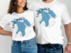 White t-shirts with blue Lake Huron map graphic and "Lake Huron Michigan".