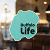 Turquoise sticker with black text "Buffalo Life" on glass.