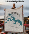Man holding Lake D'Arbonne Louisiana map woven blanket with compass design.