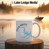 White mug with "Loch Raven Maryland" text and map design on a wooden surface.