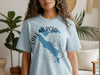 Light blue t-shirt featuring a blue outline of Lake Merced, California with compass rose graphic.