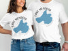 Two people in white t-shirts with "Lake Mendota Wisconsin" and map design.