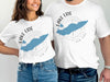 Two people wear white t-shirts with a blue Lake Erie map and "Lake Erie New York" text.