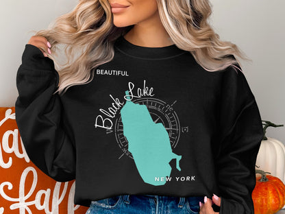 Black sweatshirt with a teal map of New York and compass rose.