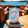 A white tumbler with a Reelfoot Lake Tennessee logo sits on a boat table.
